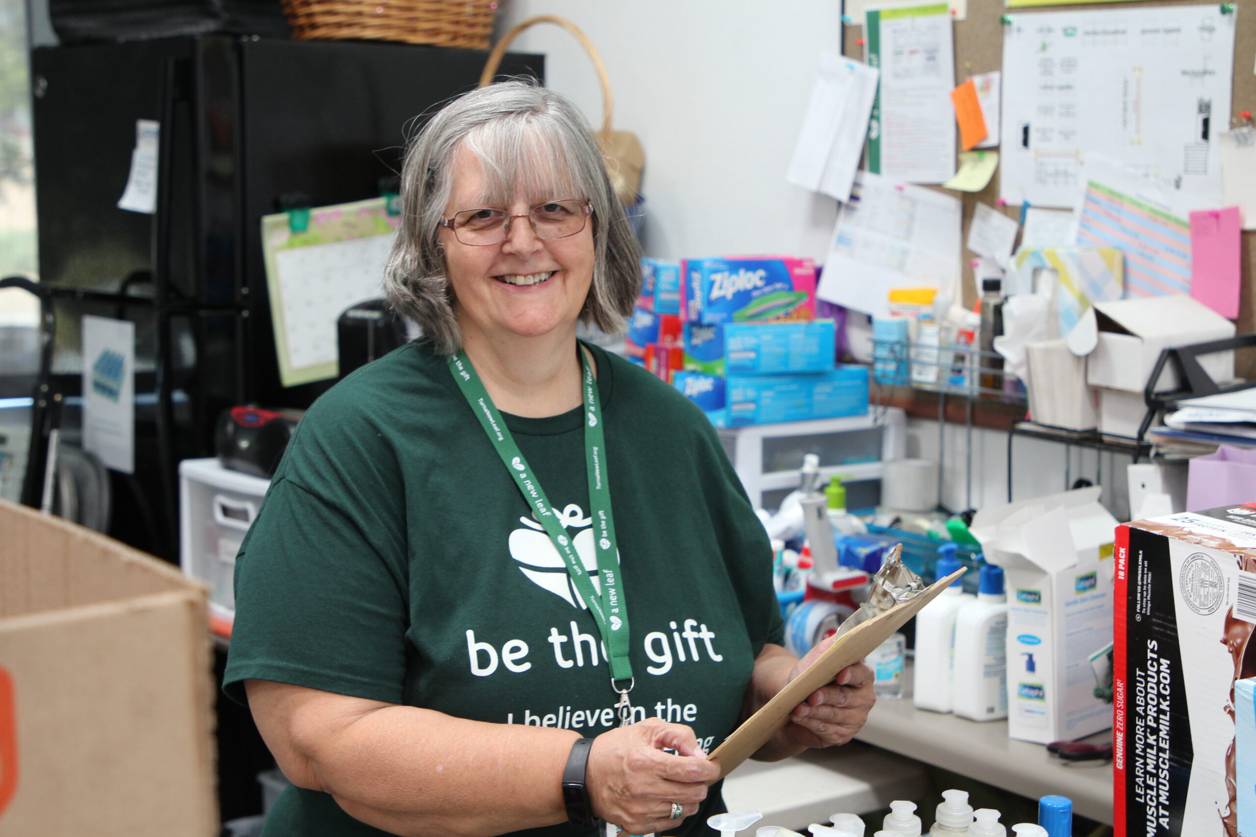 Pat holding a clipboard in A New Leaf's donation center